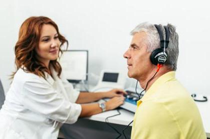 A clinician conducts a hearing screening