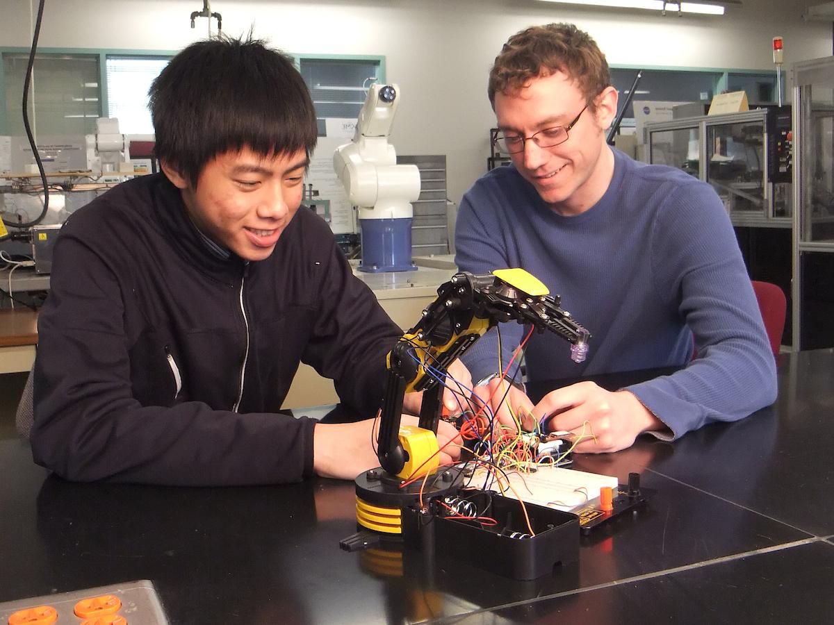 photo of two students in a lab