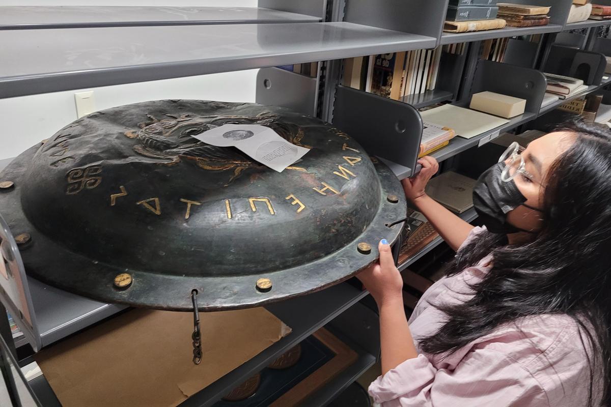 a student looking at an artifact.