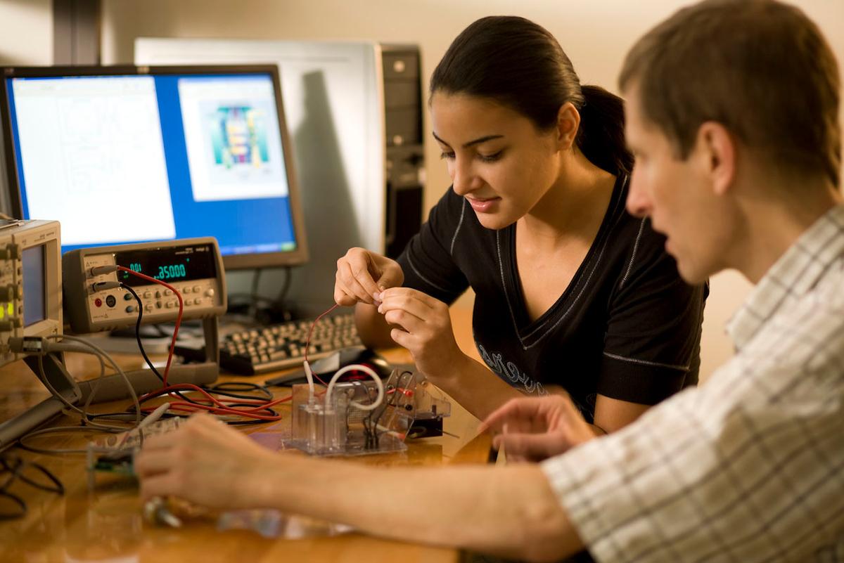 Two students with lab material