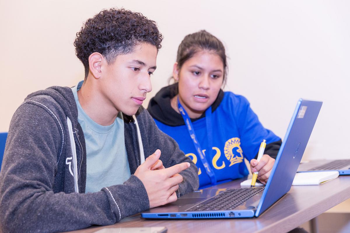 student and counselor on laptop